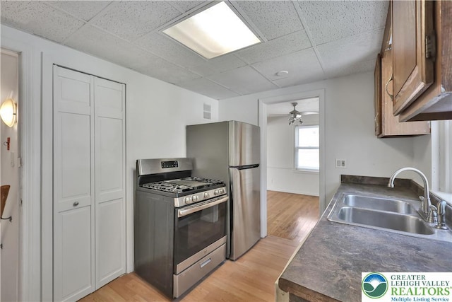 1509 Liberator Ave, Allentown City, PA 18103 - kitchen with appliances with stainless steel finishes, dark countertops, a paneled ceiling, and light wood-style floors