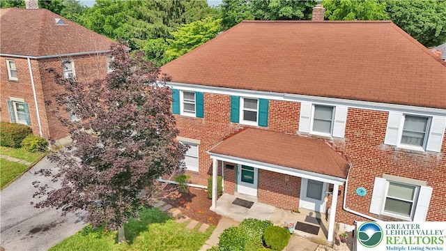 1509 Liberator Ave, Allentown City, PA 18103 - view of front of house featuring a chimney, brick siding, and a shingled roof