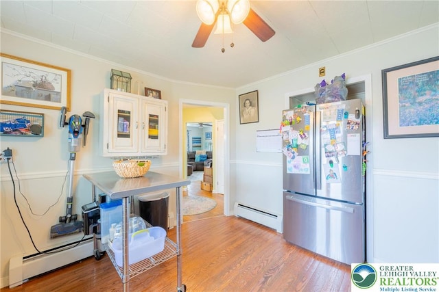 103 A St, Wind Gap Boro, PA 18091 - kitchen with freestanding refrigerator, a baseboard heating unit, ceiling fan, wood finished floors, and crown molding