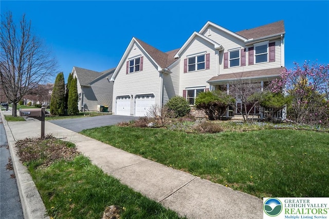 21 Millbrook Ct, Palmer Twp, PA 18045 - view of front of home with asphalt driveway, an attached garage, and a front lawn