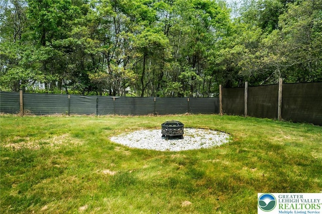2227 Cheyenne Dr, Tunkhannock Township, PA 18610 - fenced backyard featuring an outdoor fire pit