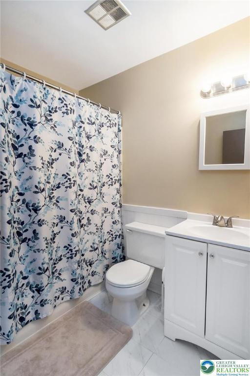 2227 Cheyenne Dr, Tunkhannock Township, PA 18610 - bathroom with vanity, marble finish flooring, and a shower with curtain