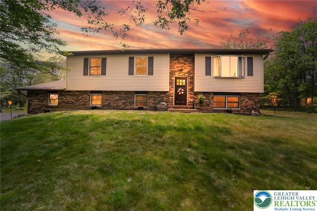 2227 Cheyenne Dr, Tunkhannock Township, PA 18610 - raised ranch with a lawn and brick siding