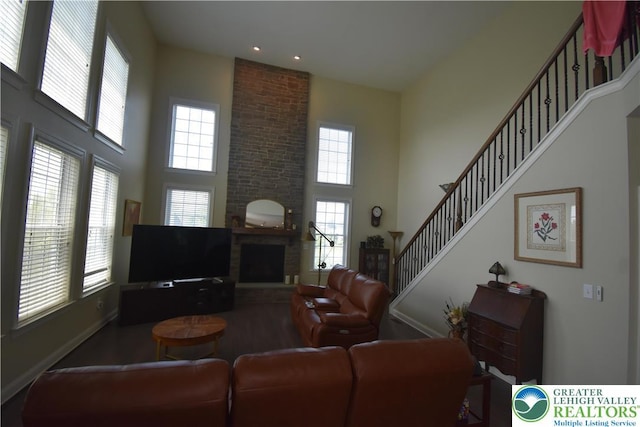 4323 Saratoga Dr, Lower Nazareth Twp, PA 18020 - living room featuring a high ceiling, a large fireplace, stairway, and recessed lighting