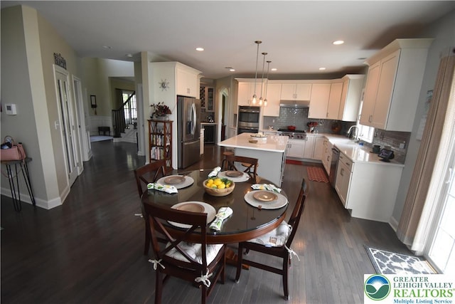 4323 Saratoga Dr, Lower Nazareth Twp, PA 18020 - dining area featuring dark wood-style flooring, stairway, healthy amount of natural light, and recessed lighting