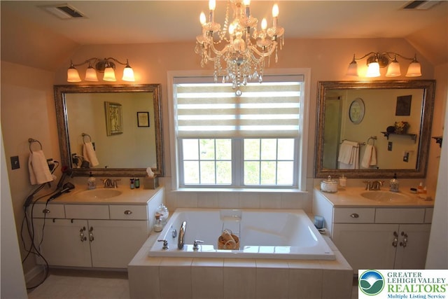 4323 Saratoga Dr, Lower Nazareth Twp, PA 18020 - full bathroom with lofted ceiling, two vanities, a garden tub, and a chandelier