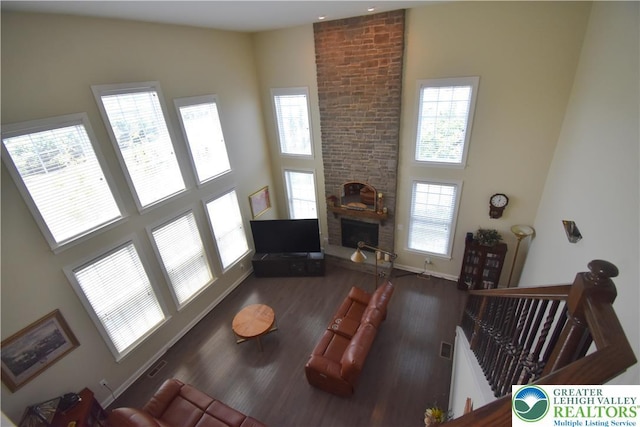 4323 Saratoga Dr, Lower Nazareth Twp, PA 18020 - living area featuring a high ceiling, healthy amount of natural light, wood finished floors, and a fireplace