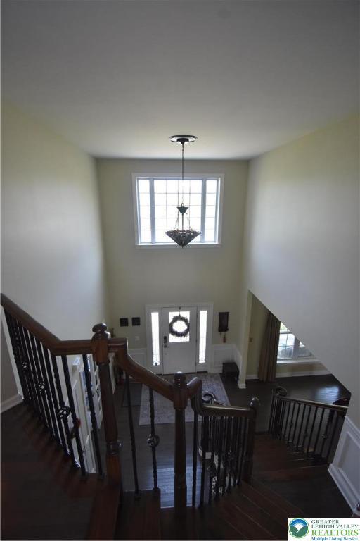 4323 Saratoga Dr, Lower Nazareth Twp, PA 18020 - foyer featuring wood finished floors, a high ceiling, and stairway