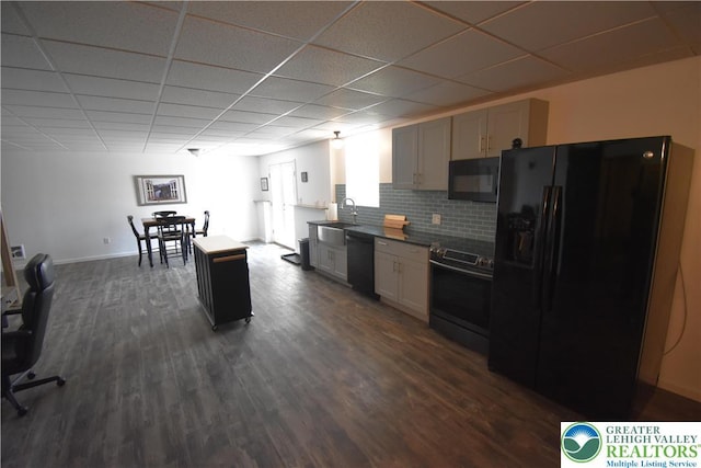 4323 Saratoga Dr, Lower Nazareth Twp, PA 18020 - kitchen with black appliances, dark wood-style flooring, a drop ceiling, decorative backsplash, and dark countertops