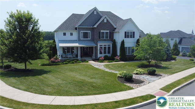 4323 Saratoga Dr, Lower Nazareth Twp, PA 18020 - view of front of property with a front lawn, covered porch, a standing seam roof, and a shingled roof