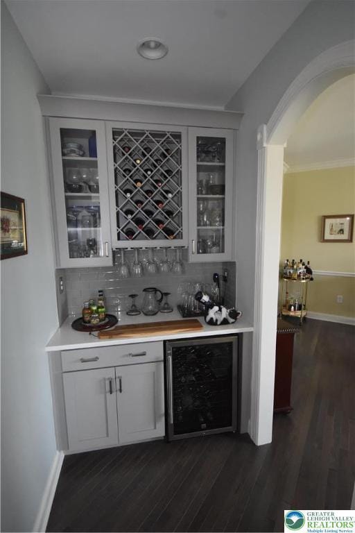 4323 Saratoga Dr, Lower Nazareth Twp, PA 18020 - indoor dry bar with beverage cooler, backsplash, and dark wood-type flooring