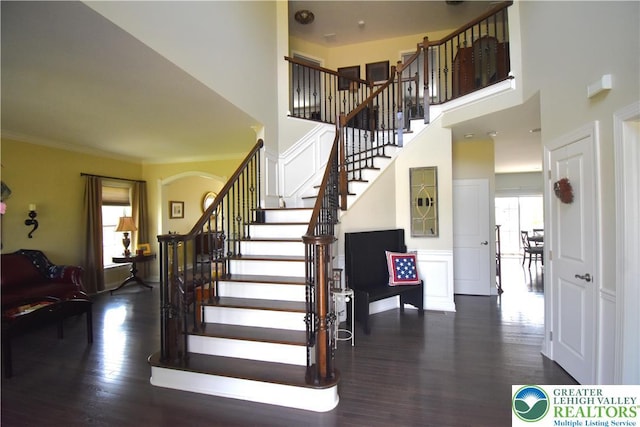 4323 Saratoga Dr, Lower Nazareth Twp, PA 18020 - stairway with wood finished floors, a high ceiling, crown molding, and arched walkways