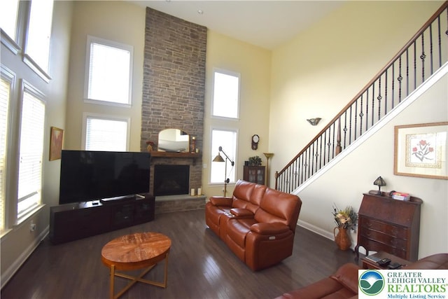 4323 Saratoga Dr, Lower Nazareth Twp, PA 18020 - living room with a towering ceiling, wood finished floors, stairs, and a brick fireplace