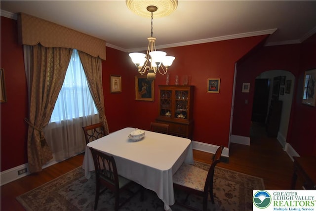 407 W Burke St, Easton, PA 18042 - dining space featuring a chandelier, wood finished floors, arched walkways, and ornamental molding