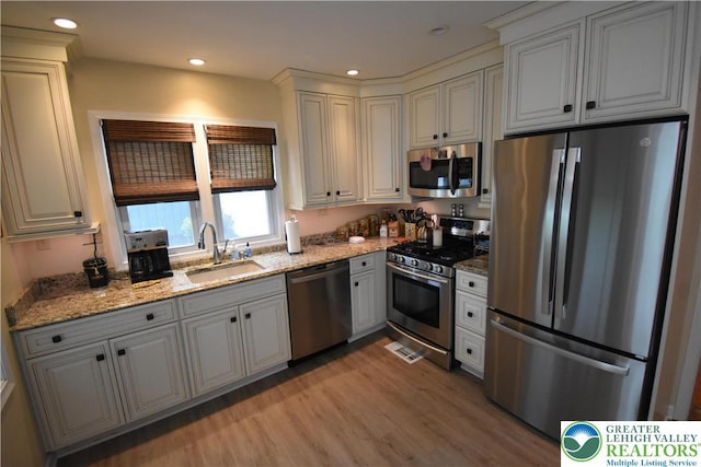 407 W Burke St, Easton, PA 18042 - kitchen with appliances with stainless steel finishes, light wood finished floors, light stone counters, and recessed lighting
