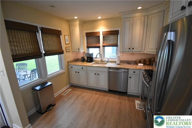 407 W Burke St, Easton, PA 18042 - kitchen featuring stainless steel appliances, light wood-style floors, light stone countertops, and recessed lighting