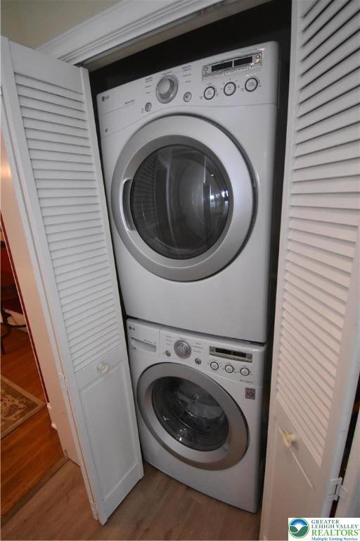 407 W Burke St, Easton, PA 18042 - laundry room featuring stacked washer and clothes dryer and wood finished floors