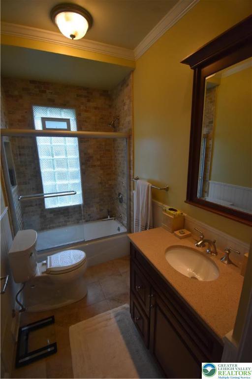 407 W Burke St, Easton, PA 18042 - bathroom with crown molding, vanity,  shower combination, and tile patterned floors