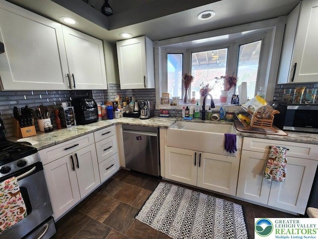14 W 10th St, Jim Thorpe Borough, PA 18229 - kitchen with stainless steel appliances, white cabinetry, backsplash, light stone countertops, and recessed lighting