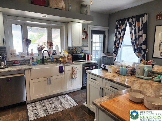 14 W 10th St, Jim Thorpe Borough, PA 18229 - kitchen featuring stainless steel appliances, white cabinetry, backsplash, and dark stone finish flooring