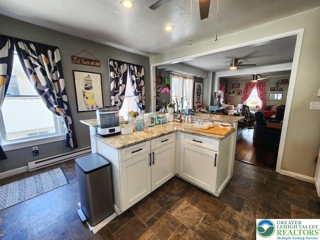 14 W 10th St, Jim Thorpe Borough, PA 18229 - kitchen with a ceiling fan, baseboard heating, white cabinets, open floor plan, and light stone counters