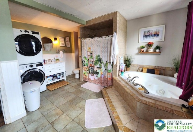 14 W 10th St, Jim Thorpe Borough, PA 18229 - full bathroom with estacked washer and dryer, a jetted tub, curtained shower, and vanity