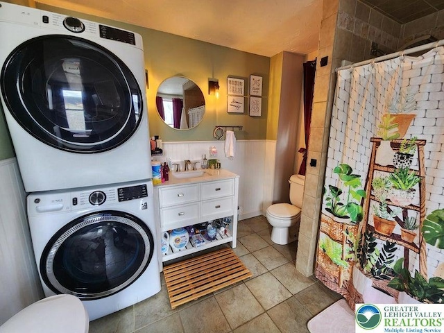 14 W 10th St, Jim Thorpe Borough, PA 18229 - laundry area featuring estacked washer and dryer, wainscoting, and light tile patterned floors
