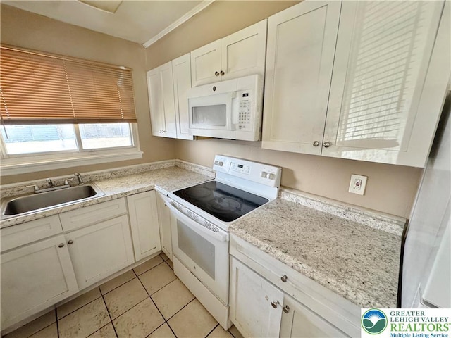 909 Genesee St, Allentown City, PA 18103 - kitchen featuring white appliances, light countertops, white cabinets, and light tile patterned flooring
