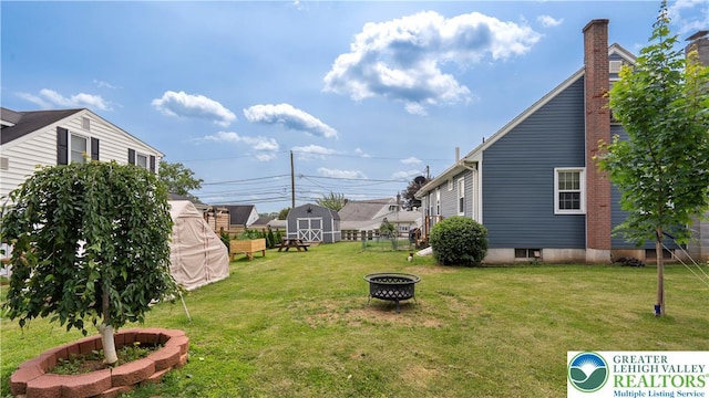 3063 Clearview St, Palmer Twp, PA 18045 - view of grassy yard featuring an outdoor fire pit and a shed
