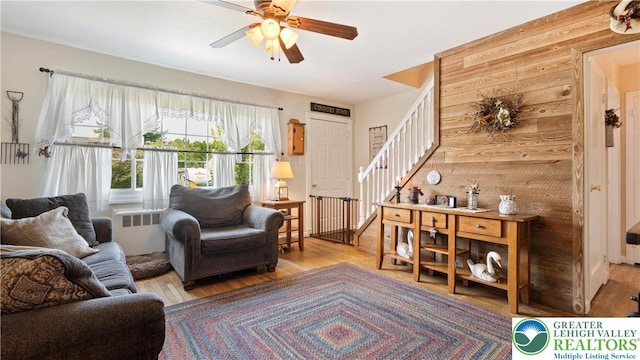 3063 Clearview St, Palmer Twp, PA 18045 - living room featuring radiator, stairs, wood finished floors, and a ceiling fan