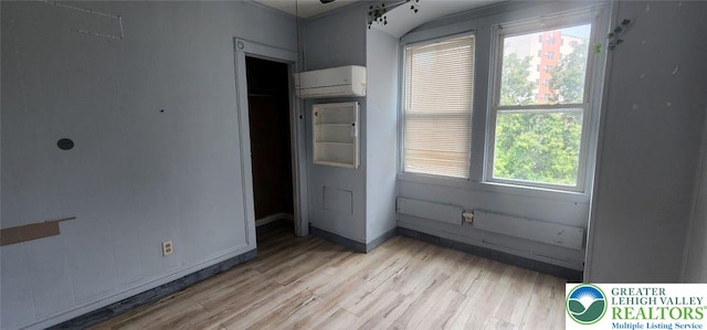2463 Hillside Ave, Wilson Boro, PA 18042 - unfurnished bedroom featuring a wall mounted air conditioner and light wood-style floors