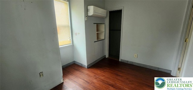 2463 Hillside Ave, Wilson Boro, PA 18042 - unfurnished bedroom with a wall unit AC and dark wood-type flooring