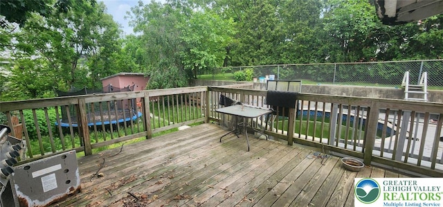 2463 Hillside Ave, Wilson Boro, PA 18042 - wooden terrace featuring a trampoline and view of wooded area