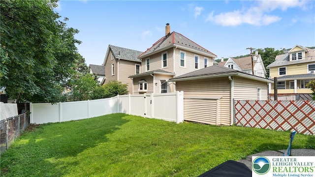 107 B St, Pen Argyl Boro, PA 18072 - back of property featuring a fenced backyard and a chimney