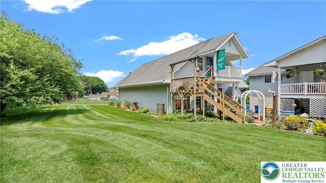 807 Bangor Rd, Plainfield Twp, PA 18064 - back of property with a yard, stairway, and a shingled roof