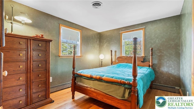 807 Bangor Rd, Plainfield Twp, PA 18064 - bedroom with a baseboard radiator, light wood finished floors, and a textured wall