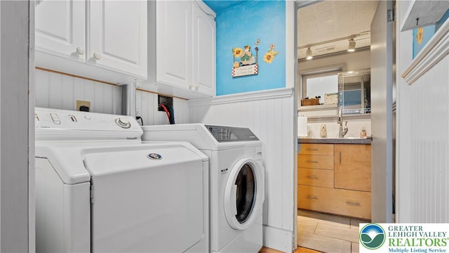 807 Bangor Rd, Plainfield Twp, PA 18064 - washroom with washer and clothes dryer, cabinet space, a wainscoted wall, and light tile patterned floors