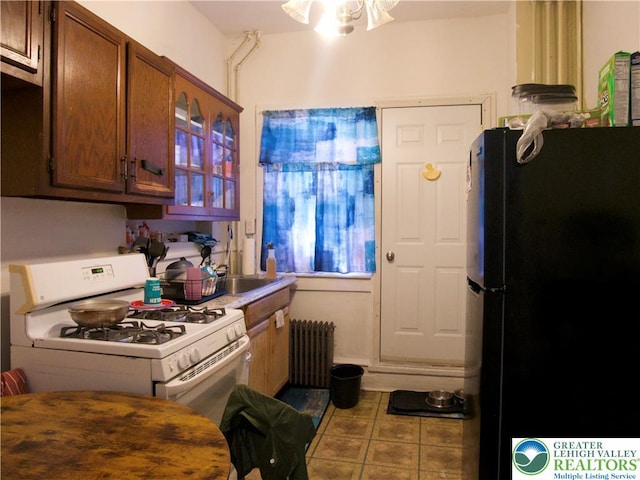 266 E Walnut St, Allentown City, PA 18109 - kitchen featuring freestanding refrigerator, white range with gas cooktop, radiator heating unit, and light countertops