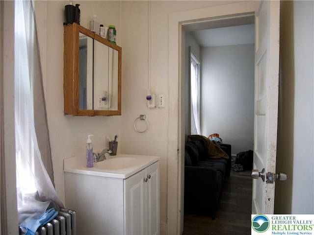 266 E Walnut St, Allentown City, PA 18109 - bathroom with vanity, radiator, and wood finished floors