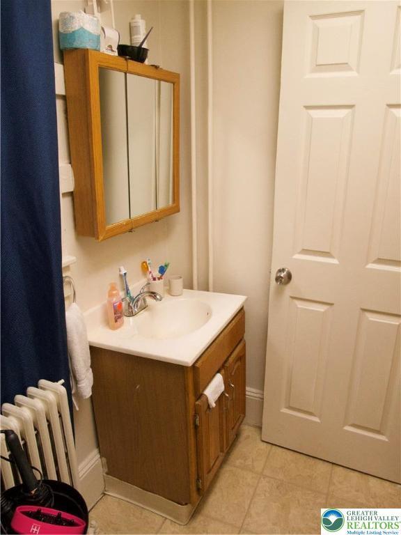 266 E Walnut St, Allentown City, PA 18109 - bathroom featuring radiator, vanity, and tile patterned flooring