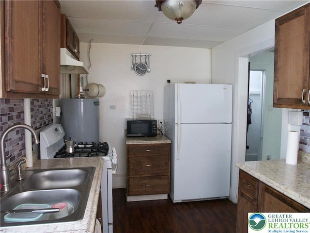 266 E Walnut St, Allentown City, PA 18109 - kitchen featuring white appliances, decorative backsplash, water heater, light countertops, and dark wood-style floors