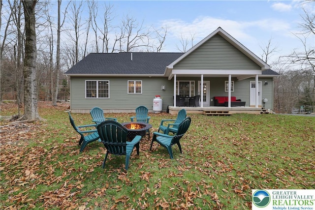 119 Tenicum Trl, Coolbaugh Twp, PA 18347 - back of house with an outdoor fire pit and a yard