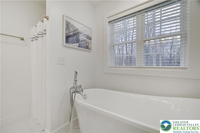 119 Tenicum Trl, Coolbaugh Twp, PA 18347 - bathroom with a freestanding tub and baseboards