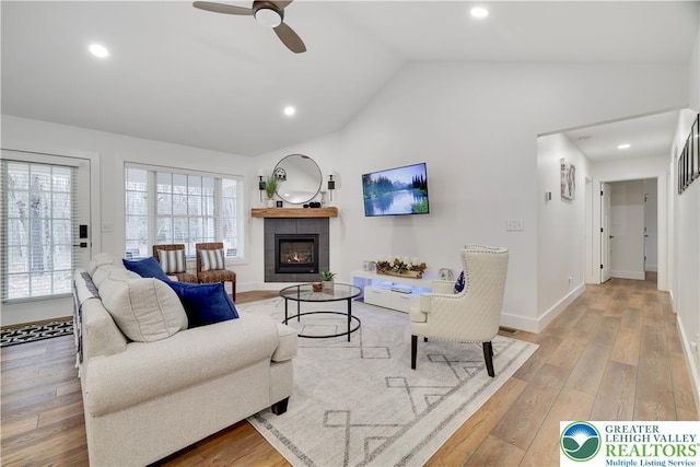 119 Tenicum Trl, Coolbaugh Twp, PA 18347 - living room featuring vaulted ceiling, a tile fireplace, light wood-style floors, a ceiling fan, and recessed lighting