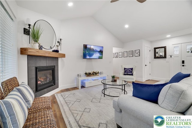 119 Tenicum Trl, Coolbaugh Twp, PA 18347 - living room with wood finished floors, a tiled fireplace, recessed lighting, vaulted ceiling, and a ceiling fan