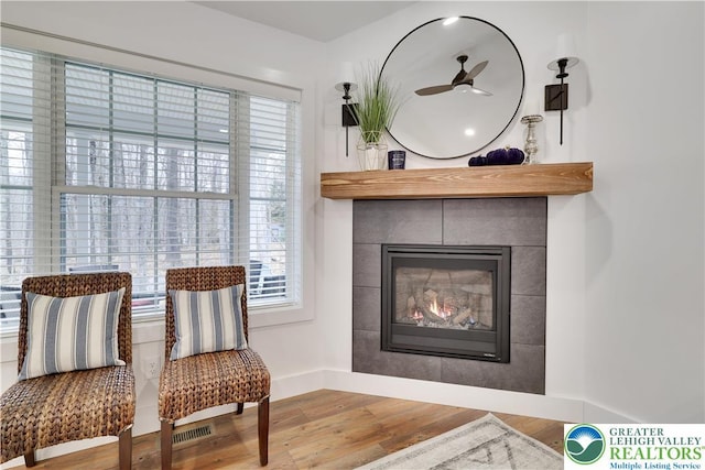 119 Tenicum Trl, Coolbaugh Twp, PA 18347 - living area featuring wood finished floors and a tiled fireplace