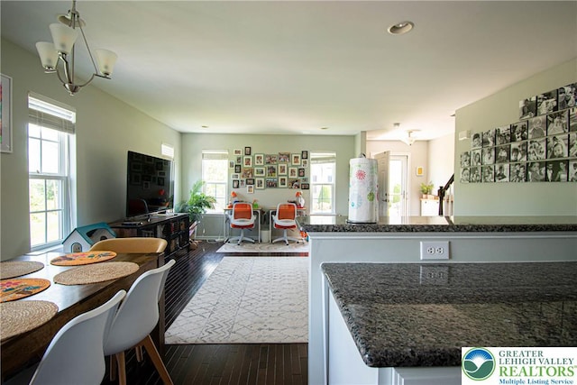 5959 Valley Forge Rd, Upper Saucon Twp, PA 18036 - kitchen with dark wood-style floors, dark stone counters, open floor plan, a chandelier, and pendant lighting