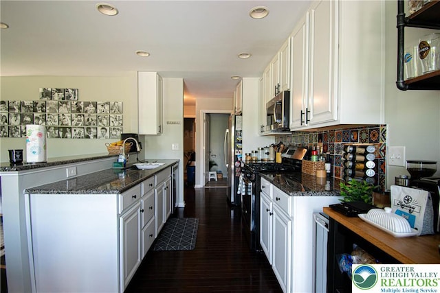 5959 Valley Forge Rd, Upper Saucon Twp, PA 18036 - kitchen featuring stainless steel appliances, white cabinetry, dark stone counters, decorative backsplash, and recessed lighting