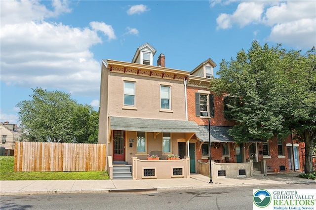 337 N 10th St, Allentown City, PA 18102 - townhome / multi-family property featuring a porch, brick siding, and a chimney