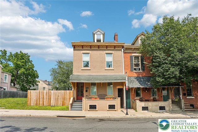 337 N 10th St, Allentown City, PA 18102 - townhome / multi-family property with a porch, brick siding, and a chimney